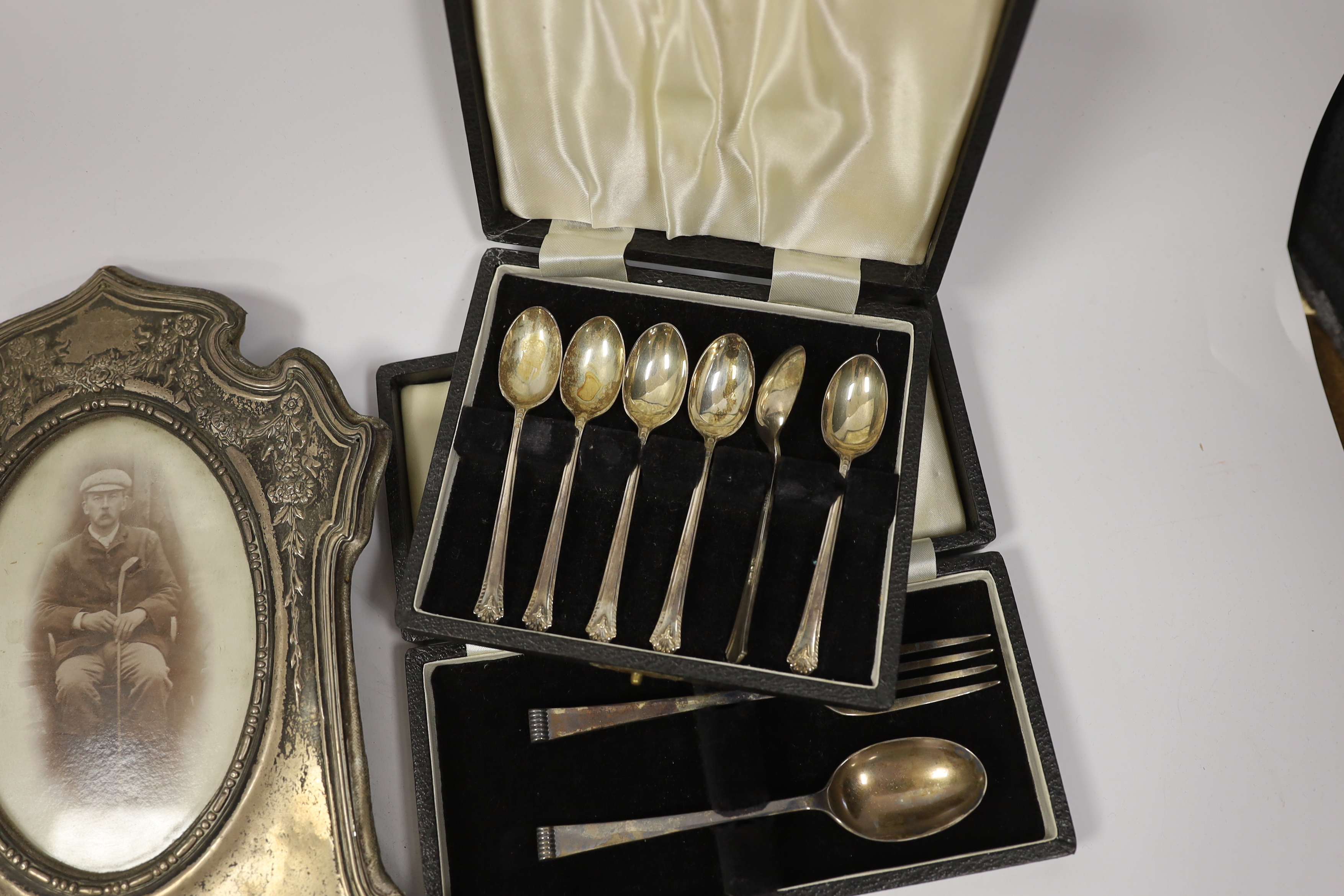 Miscellaneous items including three cased sets of silver flatware including enamelled teaspoons, Halcyon Days boxes, cased barometer, gilt metal case, silver mounted photograph frame, etc.